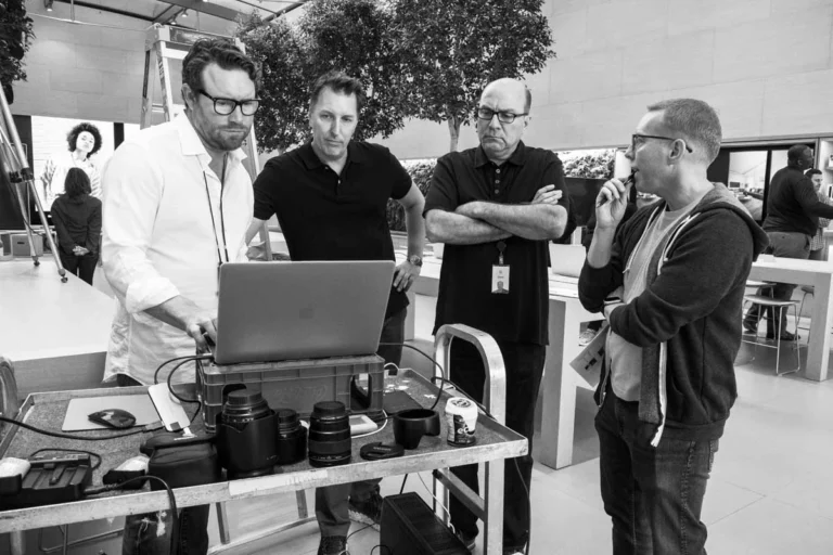 Executive portrait photographer reviewing images with client and creative team during a commercial production