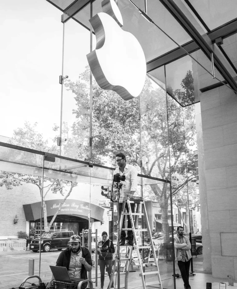 Executive portrait photographer directing a commercial production for Apple inside a retail environment