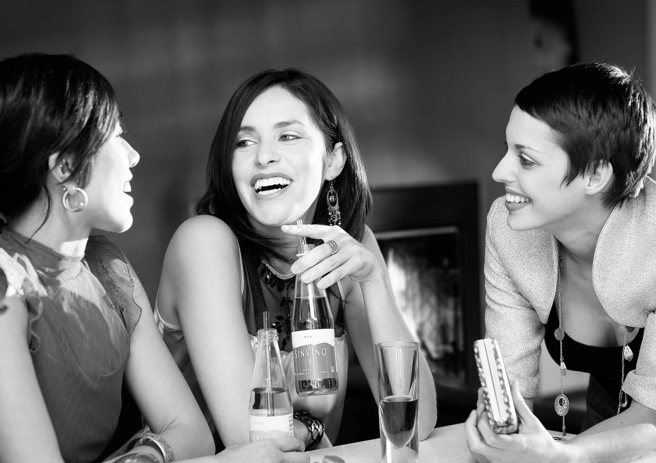 Black and white personal branding portrait for a beverage advertisement featuring three women in a social setting in Copenhagen – Personal Branding Portrait Photographer Copenhagen