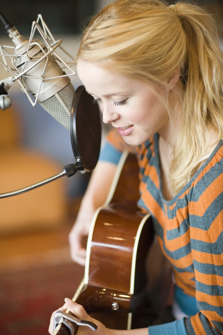 Personal branding portrait of singer Tina Dico playing guitar in a recording studio – Personal Branding Portrait Photographer Copenhagen